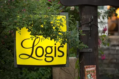 a yellow sign that says josias attached to a pole at Logis hôtel restaurant Auberge de l'Espinouse in Fraisse-sur-Agout