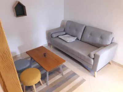 a living room with a couch and a table at La Coulée Douce - Chez Antoine in Castelnaudary