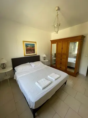a bedroom with a large bed with two towels on it at Maison de la Fontaine in Embres-et-Castelmaure