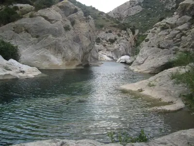 a body of water in a rocky canyon at Maison de la Fontaine in Embres-et-Castelmaure