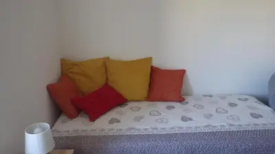 a bunch of pillows sitting on a bed in a room at La maison de l'écluse in Trèbes