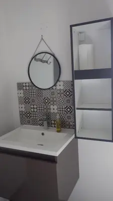 a bathroom with a white sink and a mirror at La maison de l'écluse in Trèbes
