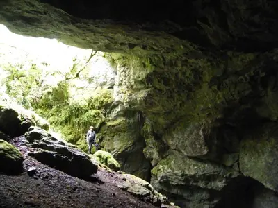 a man standing in front of a cave at L'Ostalet in Prugnanes