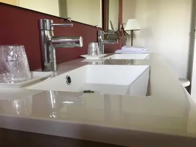 a bathroom with a white sink and a mirror at Chambres Ambroisie in Gueytes-et-Labastide