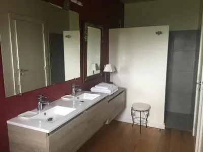 a bathroom with two sinks and a large mirror at Chambres Ambroisie in Gueytes-et-Labastide