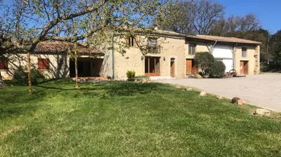 a house with a yard in front of a house at Chambres Ambroisie in Gueytes-et-Labastide