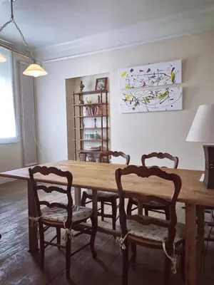a wooden dining room table with two chairs and a table at Les Chambres des Barques in Narbonne