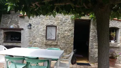 a table and chairs in front of a building at Villa La Milouyette in Peyriac-Minervois