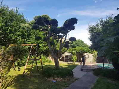 a tree with a ladder in a yard at Villa La Milouyette in Peyriac-Minervois