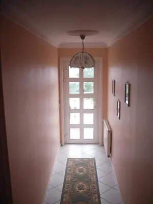 a hallway with a window and a door with a rug at Domaine de la Pendule in Issel
