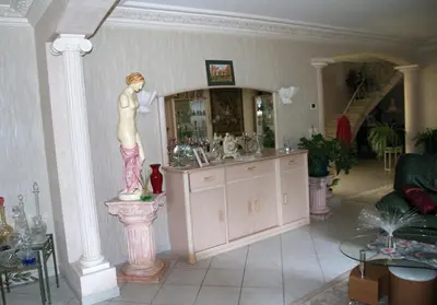 a statue of a woman on a column in a room at Domaine de la Pendule in Issel