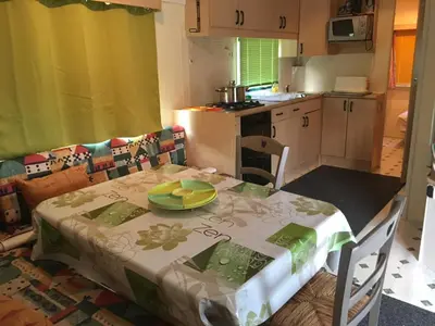 a kitchen with a table with a plate on it at Parc Des Oliviers in Gaudiès