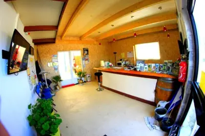 a view of a kitchen with a bar in a room at Parc Des Oliviers in Gaudiès