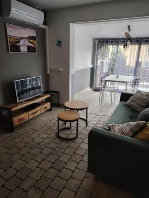 a living room with a couch and a table at 480 Rue de la Hune in Gruissan