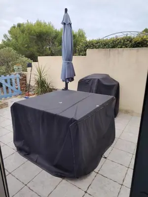 a black table with an umbrella on top of it at 480 Rue de la Hune in Gruissan