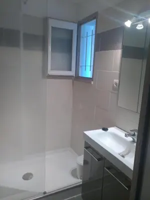 a bathroom with a sink and a toilet and a window at logis 194 in Gruissan