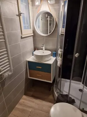 a bathroom with a sink and a mirror at logis 149 in Gruissan
