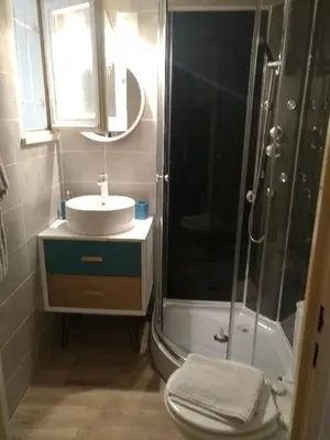 a bathroom with a sink and a shower at logis 149 in Gruissan