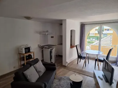 a living room with a couch and a table at logis 149 in Gruissan