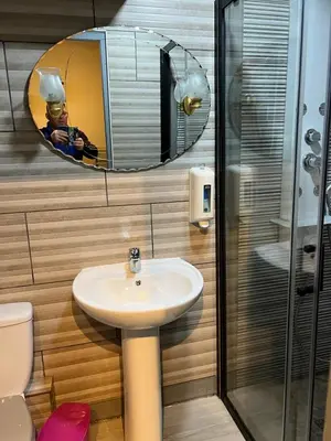 a bathroom with a sink and a mirror at maison des corbieres in Conilhac-Corbières
