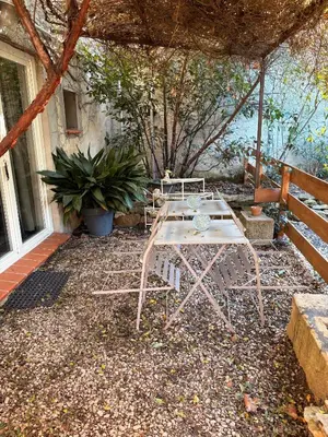 a table and chairs sitting on a patio at L'Ecurie en ville in Limoux