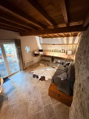 a living room with a couch and a table at L'Ecurie en ville in Limoux