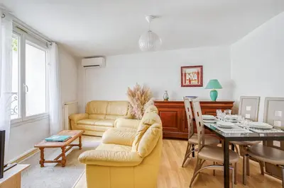 a living room with a couch and a table at Le Narbona in Narbonne