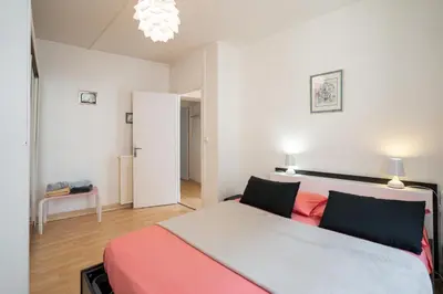 a bedroom with a large bed with red and grey at Le Narbona in Narbonne