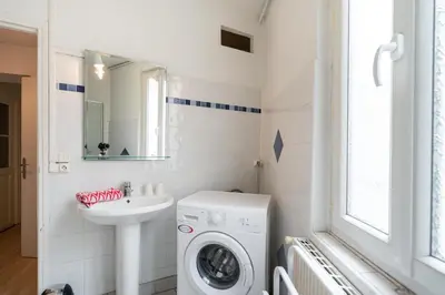 a bathroom with a washing machine and a sink at Le Narbona in Narbonne