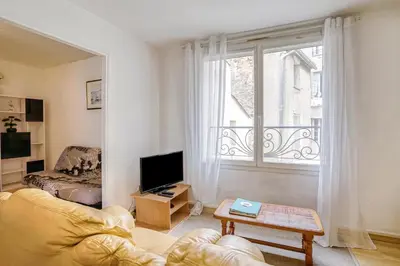 a living room with a couch and a window at Le Narbona in Narbonne
