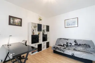 a living room with a bed and a desk at Le Narbona in Narbonne