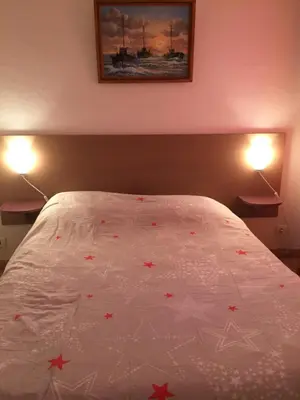 a bedroom with a bed with red stars on it at Résidence les jardins du phoebus appartement in Gruissan