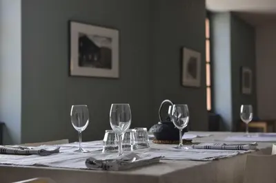 a table with wine glasses and napkins on it at Appartement d'Hôtes Temps de Pause in Lautrec