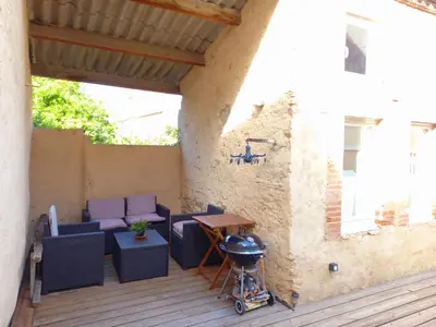 a patio with purple furniture and a grill at TERRASSE du GET in Revel