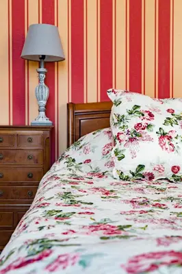 a bed with a pillow and a lamp in a room at La Maison des Palmiers in Homps