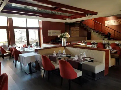 a dining room with tables and red chairs at Ile du Gua Suites in Narbonne