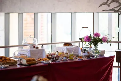 a table with food and bread and flowers on it at Ile du Gua Suites in Narbonne
