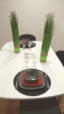 a white table with a plate and glasses on it at 