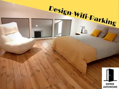 a bedroom with a bed and a white chair at 
