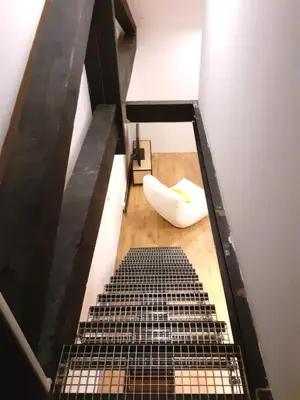 a view from the top of a room with a stairs at 