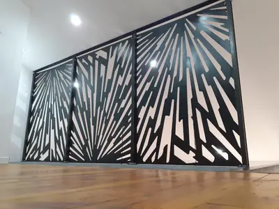 a black and white wall with a wooden floor at 