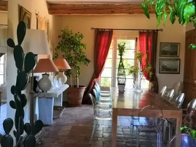 a dining room with a table and chairs at Chambre d'Hôtes au Domaine du Soleil Couchant in Saint-André-de-Roquelongue