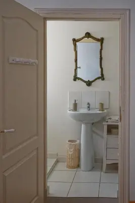 a bathroom with a sink and a mirror on the wall at Maison Rives - Village du Livre de Montolieu in Montolieu