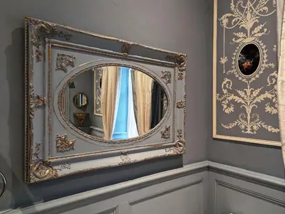 a mirror with a gold frame on a wall at Chateau de Thuries in Revel