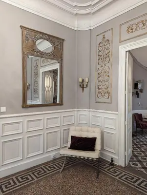 a white room with a mirror and a chair at Chateau de Thuries in Revel