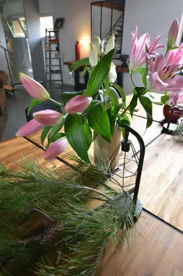 a vase filled with pink flowers on a table at CHAMBRE D’HÔTES NATURE ET SAVEURS in Boutenac