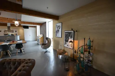 a living room with a couch and a table at CHAMBRE D’HÔTES NATURE ET SAVEURS in Boutenac