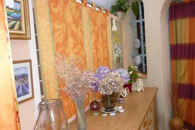 a table with vases of flowers on it at LES BRUYERES chambre d'hôte de charme Calme assuré in Loupia