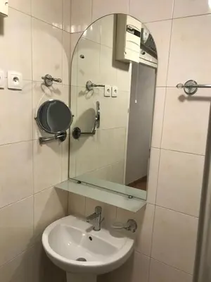 a bathroom with a sink and a mirror at Appartement du Couvent in Narbonne