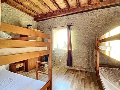 a bedroom with two bunk beds and a window at GITES STE CATHERINE in Teyssode